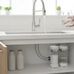 Modern kitchen with clear filtered water flowing from faucet, sleek water filter system visible.