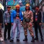 Diverse young people in stylish streetwear in an urban setting, reflecting cultural impact.